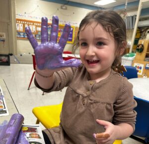 preschooler with hand paint
